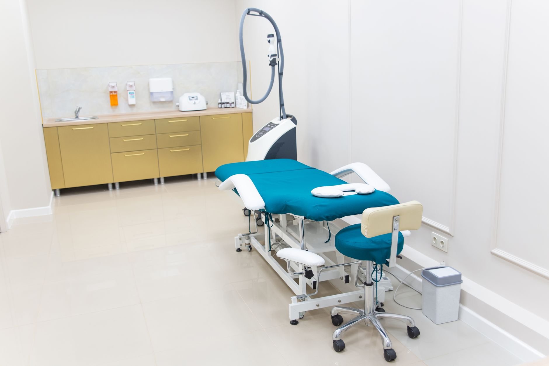 Clean and modern medical examination room with equipment ready for use.
