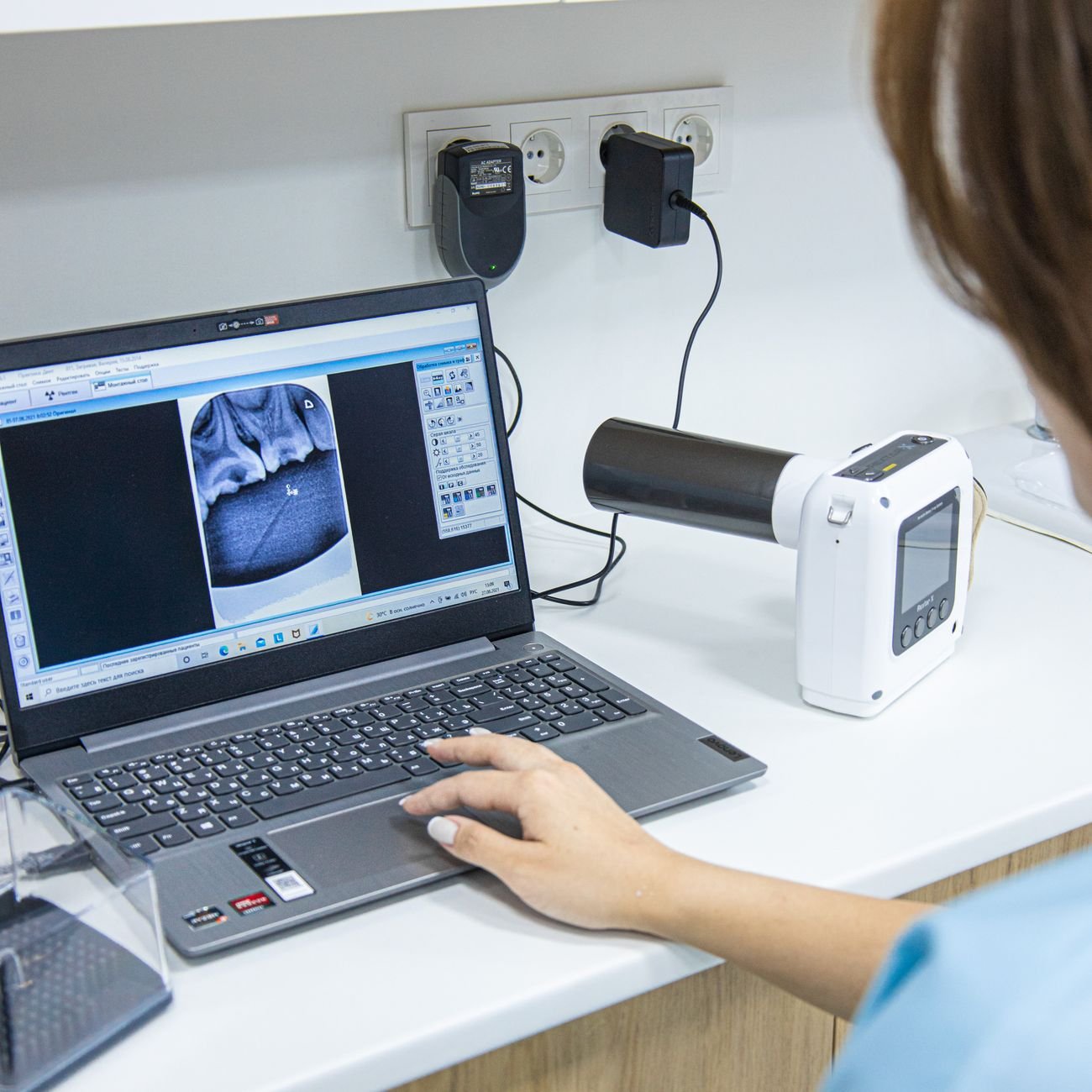 Medical professional working in a modern clinic environment.